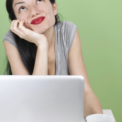 A woman thinks while using the computer