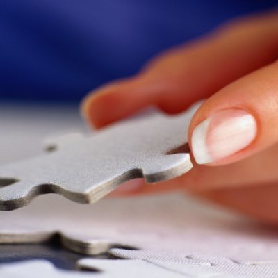 A woman putting together a puzzle