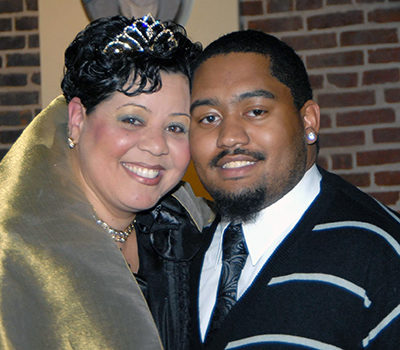 A couple with a woman wearing crown, and a man with facial hair