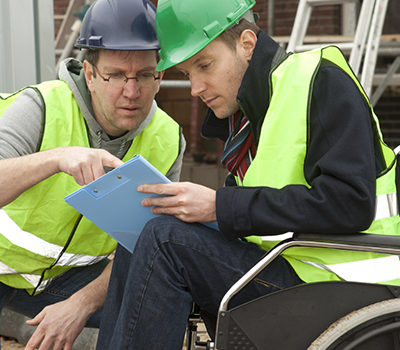 Man in wheelchair after acident at work. Worker suffering from an illness.