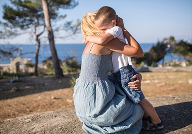 Older woman comforting a young boy