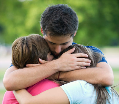 A family hugging after a prisoner's release