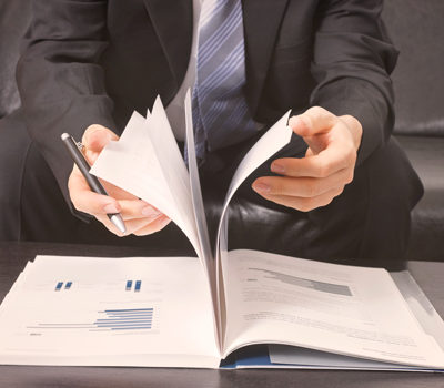 A man flipping through paper pages