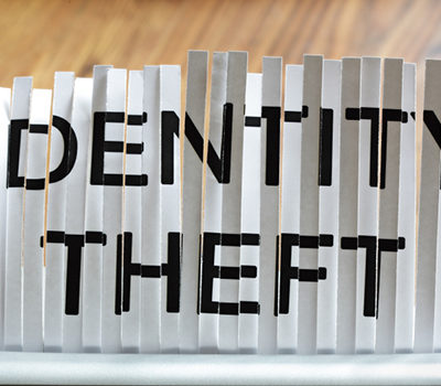 A shredded paper through a scanner saying "IDENTITY THEFT"