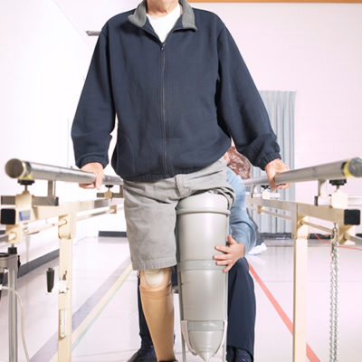 A man learning to walk with a cast