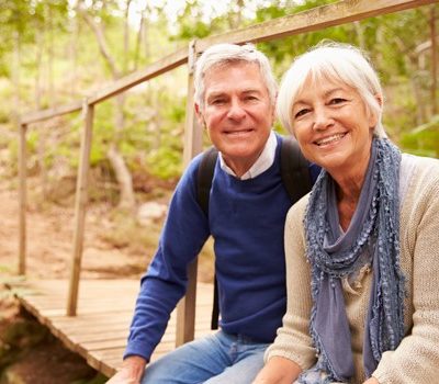 A man and woman smiling at the camera