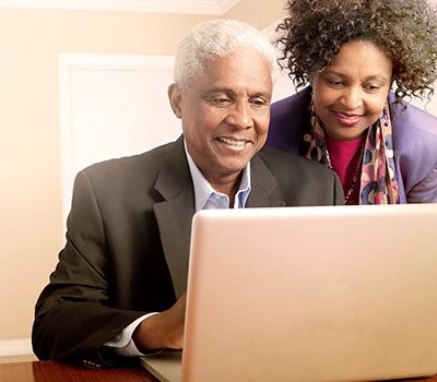 A man and woman on a laptop