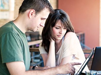 A man and woman on a laptop