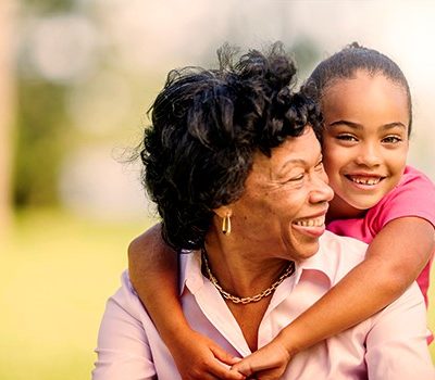 A little girl hugging older woman