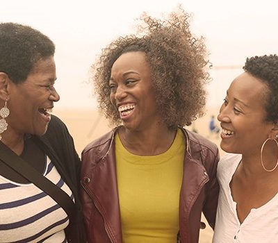 Three women smiling and laughing