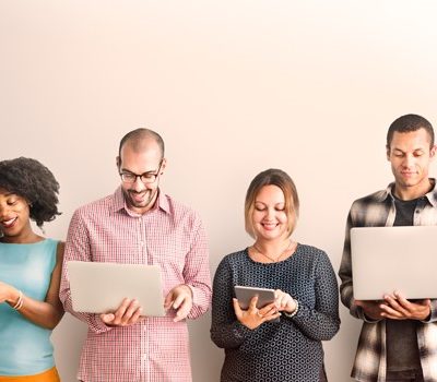 Four people reading information on their own individual devices