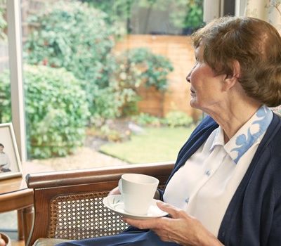 elderly woman drinking coffee