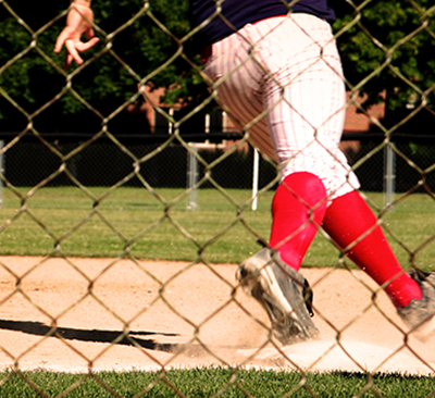 A baseball player running around first base