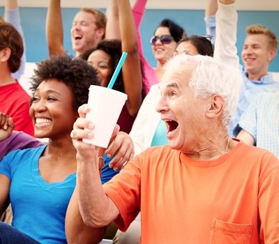 A group of people cheering at a sporting event