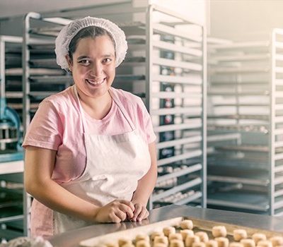 A woman baking at her place of employment