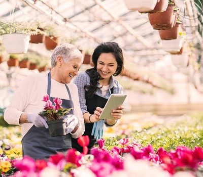 Two women picking flowers