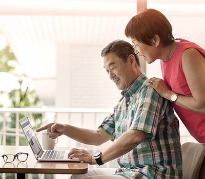 An older couple watching a stream on Facebook live