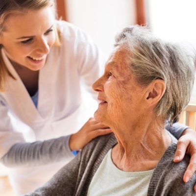 A nurse talking to an elderly woman