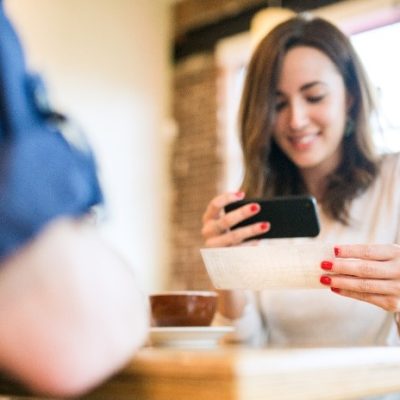 A woman holding phone and smiling