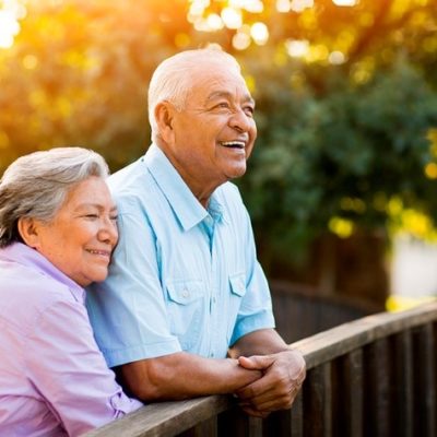 man and woman on balcony outside smiling