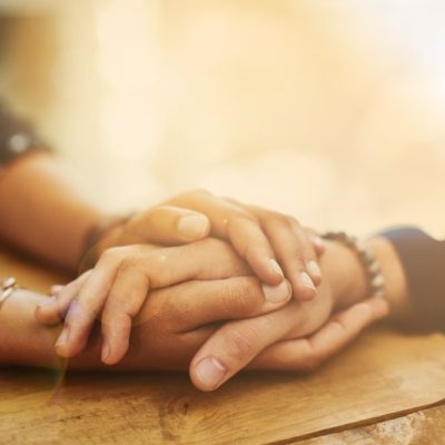 A pair of hands holding another person's hand