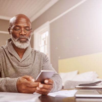 An older man using a cellphone