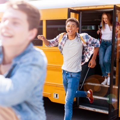 A group of school kids walking off a school bus