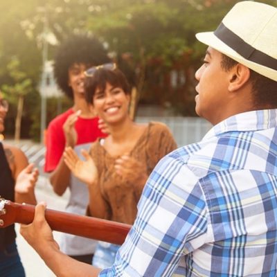 A man playing guitar for a group of people