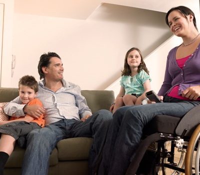 A family sitting in a living room having a genuine family moment