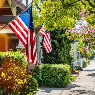 Houses with American flags hoisted on the front porches.