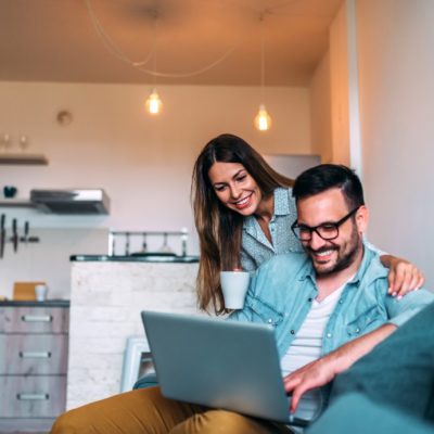 A younger couple working a laptop.