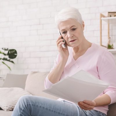 A woman on couch making a phone call