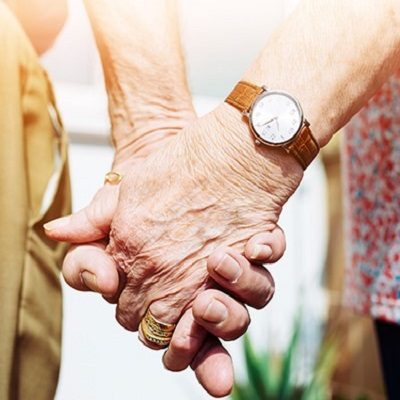 Older couple holding hands