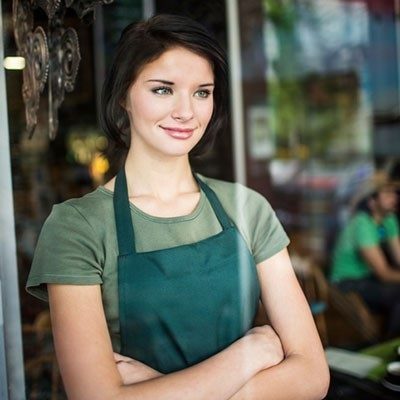 Woman standing with her arms cross at work.