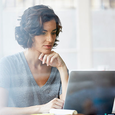 woman reviewing information on laptop