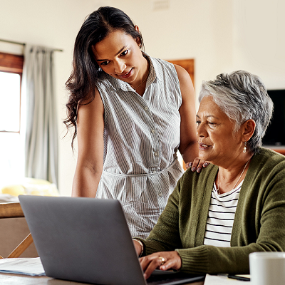 young woman and older woman reviewing information on a laptop