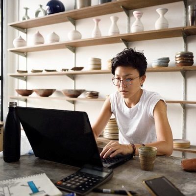 woman sitting at a desk on a laptop computer