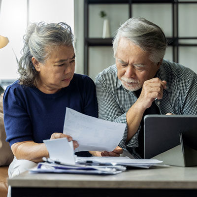 senior couple checking laptop