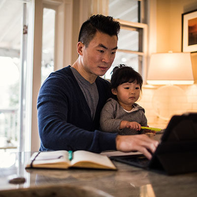 Father working in kitchen with daughter