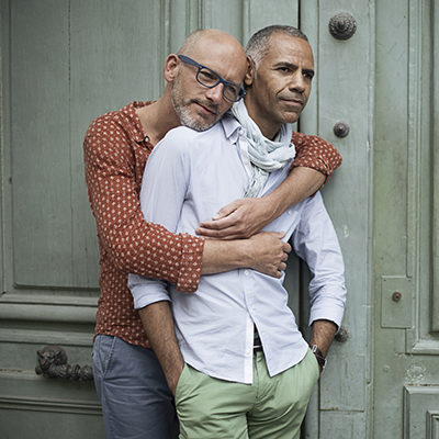 A male couple standing together.