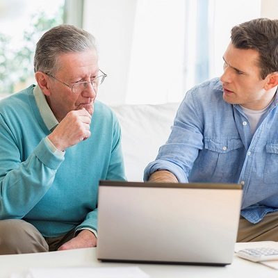 Man helping father use computer