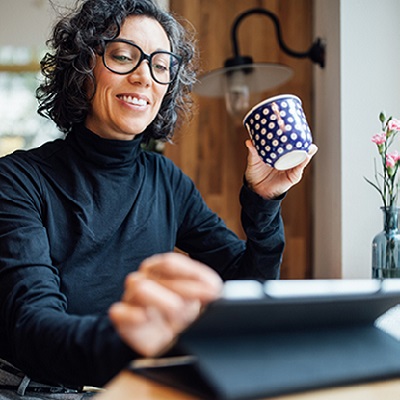 Person reviewing online earnings history on tablet