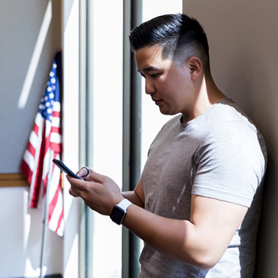 Mid adult veteran takes time from meeting to text wife