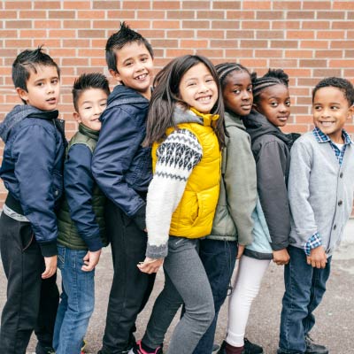 A photo of a group of kids posing.