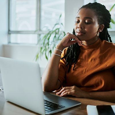 A young woman looking at a computer.