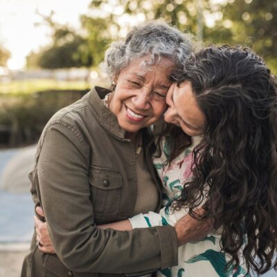 Older and younger woman hug