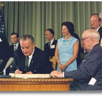 A photo of Lyndon B. Johnson signing a bill.